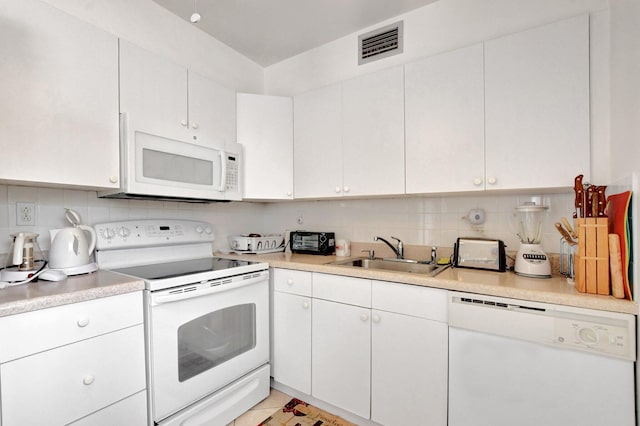 kitchen featuring backsplash, sink, white cabinets, and white appliances