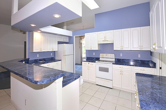 kitchen with a kitchen breakfast bar, light tile patterned floors, white cabinets, and white appliances