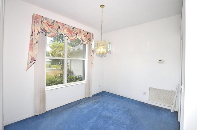 unfurnished dining area with an inviting chandelier, dark carpet, and a healthy amount of sunlight