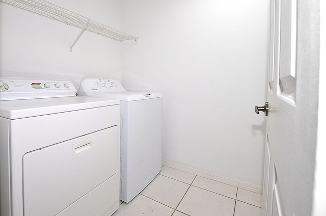 laundry area featuring independent washer and dryer and light tile patterned floors