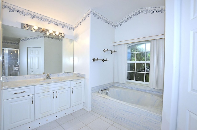 bathroom with tile patterned floors, vanity, and separate shower and tub