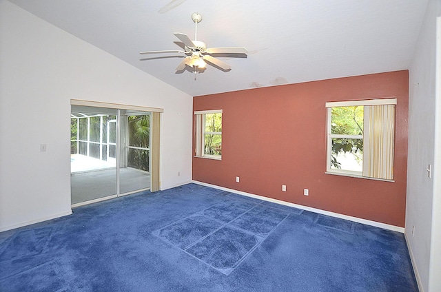 spare room with dark carpet, vaulted ceiling, plenty of natural light, and ceiling fan