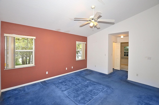 spare room featuring dark colored carpet, ceiling fan, and lofted ceiling