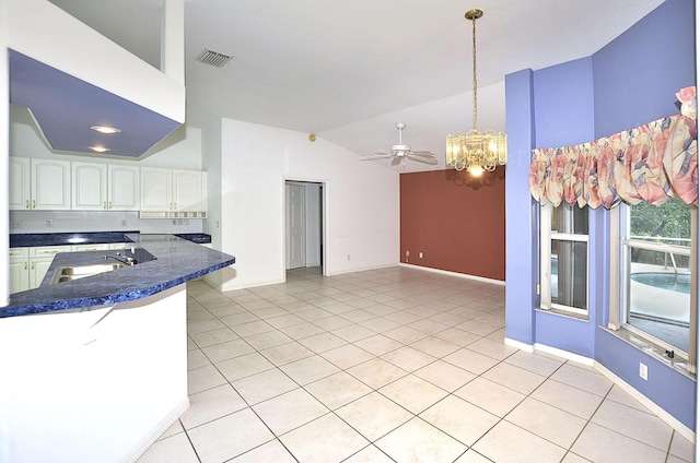 kitchen with sink, kitchen peninsula, decorative light fixtures, white cabinets, and ceiling fan with notable chandelier