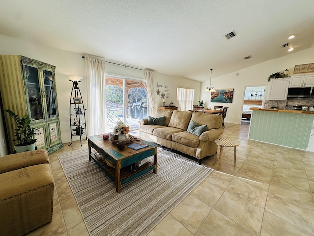 tiled living room featuring a textured ceiling and lofted ceiling