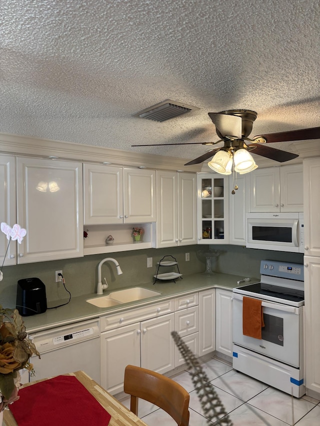 kitchen with white appliances, ceiling fan, sink, white cabinetry, and light tile patterned flooring