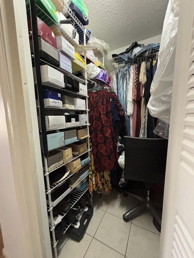 walk in closet with tile patterned floors