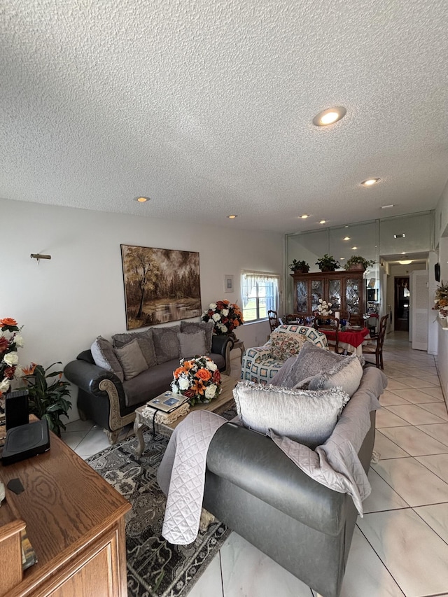 tiled living room featuring a textured ceiling