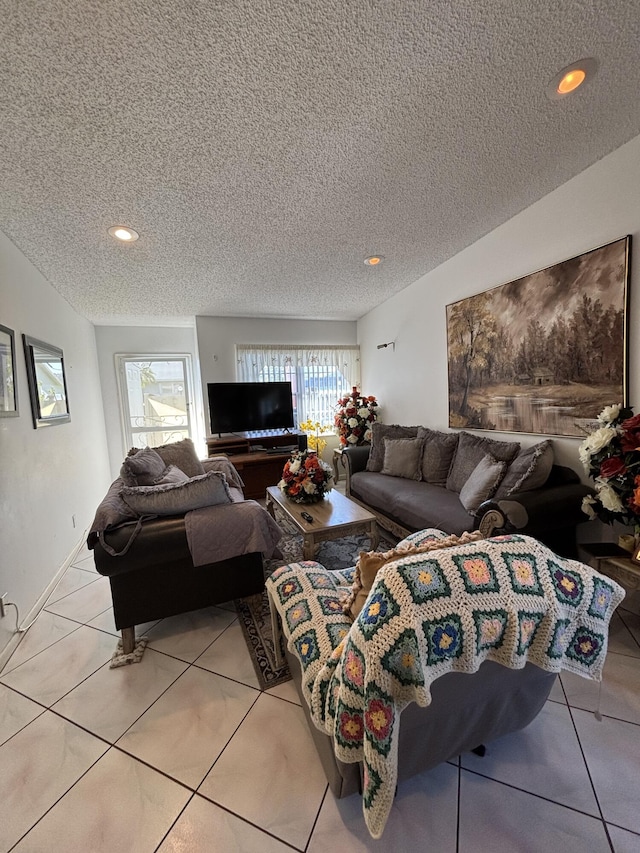 tiled living room featuring a textured ceiling