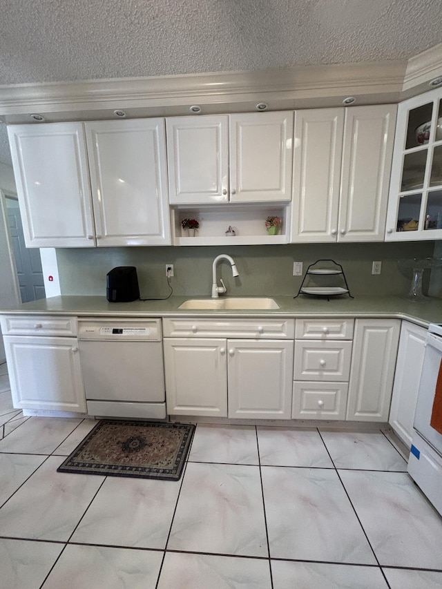 kitchen featuring dishwasher, white cabinets, and sink