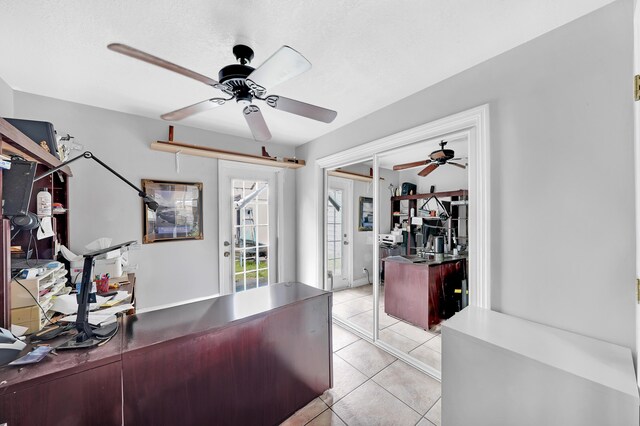 tiled office featuring a textured ceiling, ceiling fan, and french doors