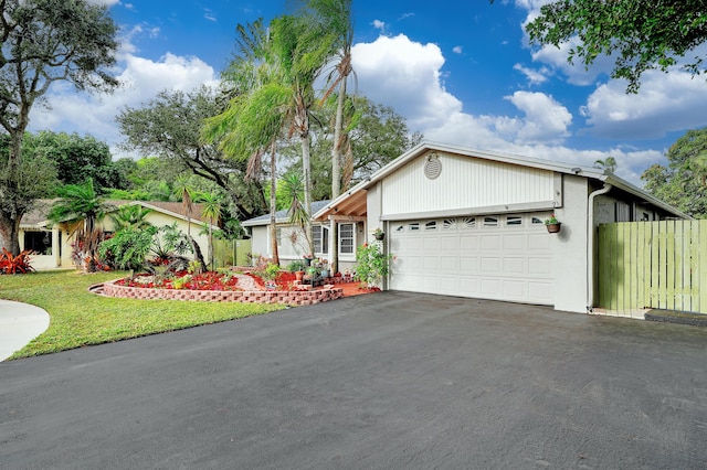 ranch-style home with a garage and a front yard