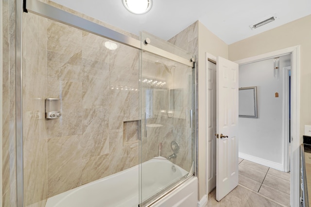 bathroom with tile patterned flooring and combined bath / shower with glass door