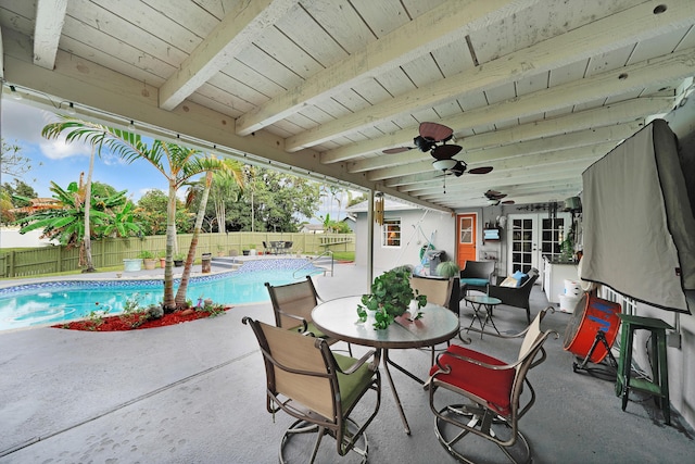 view of patio featuring a fenced in pool and ceiling fan