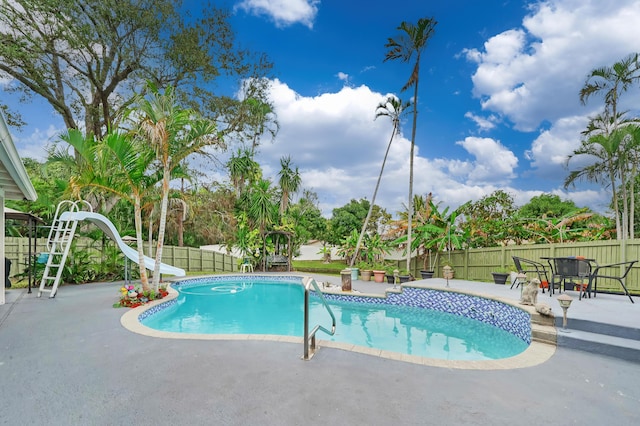 view of pool featuring a patio and a water slide