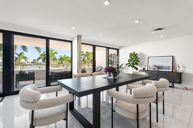 tiled dining space with french doors and expansive windows