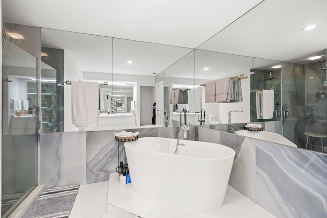 bathroom featuring tile walls and independent shower and bath