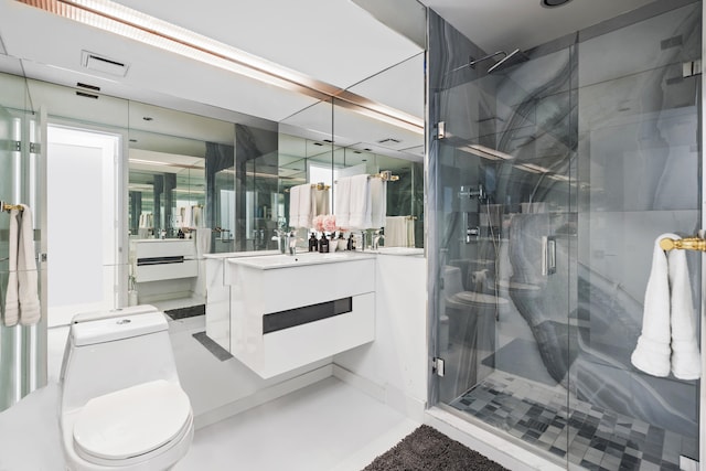 bathroom featuring vanity, toilet, and a shower with shower door