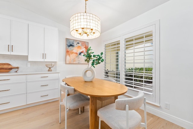 dining room featuring a notable chandelier and light hardwood / wood-style flooring