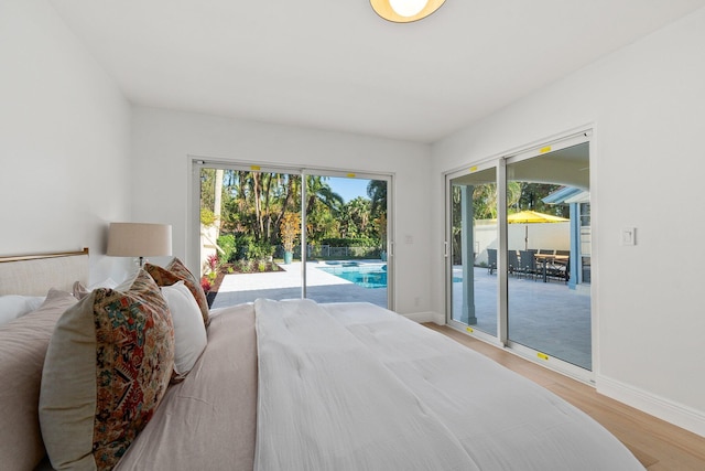 bedroom with access to outside and light hardwood / wood-style flooring