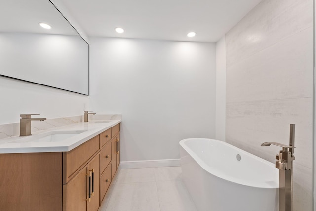 bathroom featuring vanity, a tub to relax in, and tile patterned flooring