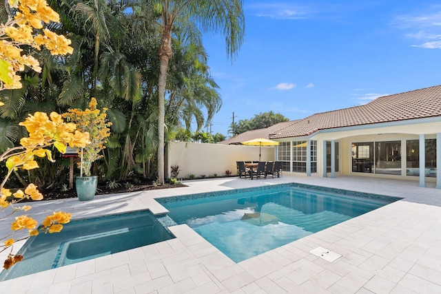 view of swimming pool featuring a patio and an in ground hot tub