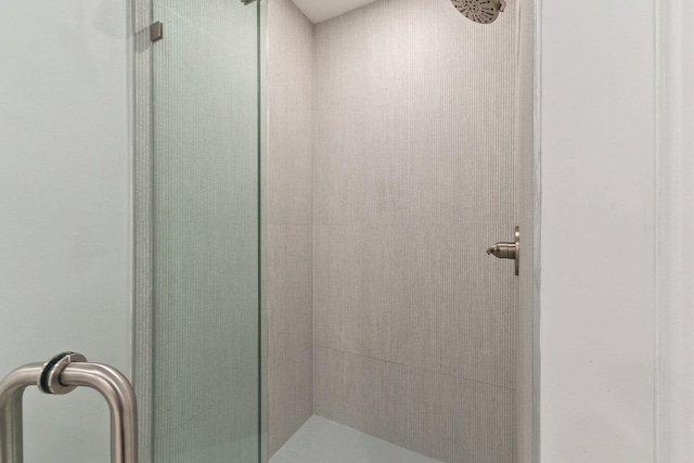 bathroom with a shower with shower door