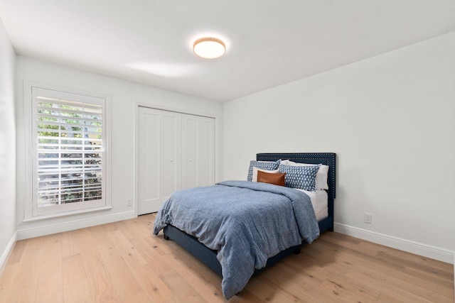 bedroom featuring light hardwood / wood-style floors and a closet