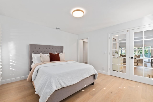 bedroom with light hardwood / wood-style flooring and french doors