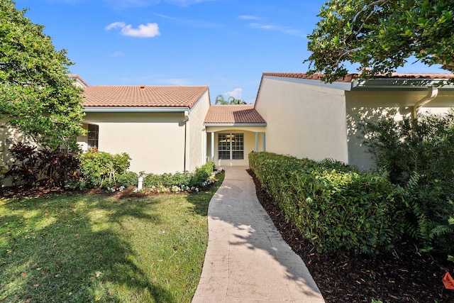 mediterranean / spanish house with a front yard