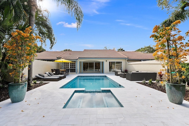 view of swimming pool featuring an in ground hot tub, an outdoor living space, and a patio area