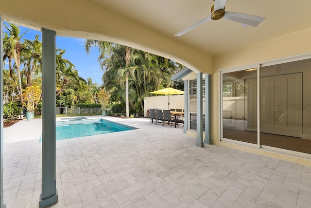 view of swimming pool with ceiling fan and a patio area