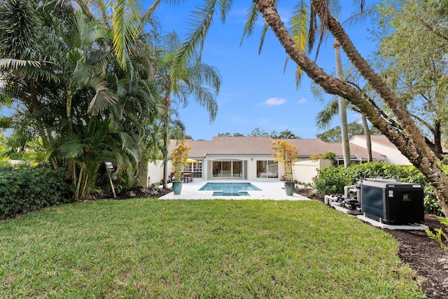 back of property with a patio and a lawn