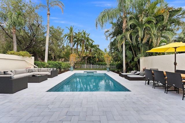 view of swimming pool with an outdoor living space and a patio area