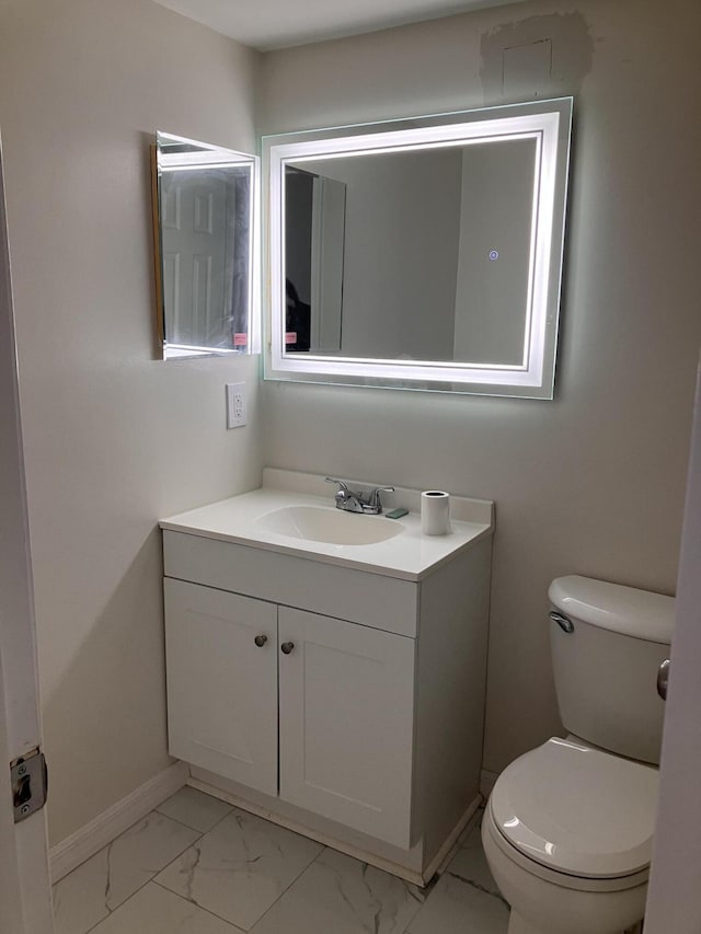 bathroom featuring vanity and toilet