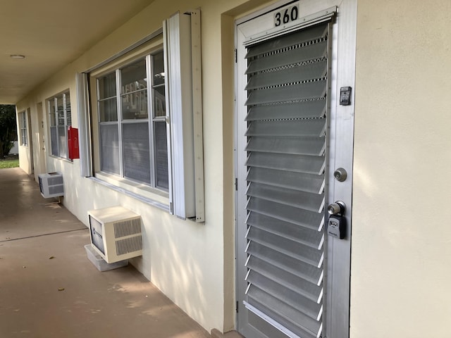 property entrance with a wall mounted AC