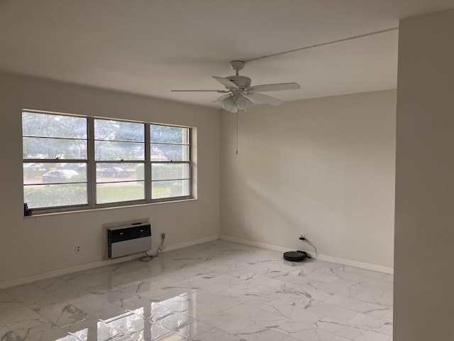 empty room featuring heating unit and ceiling fan