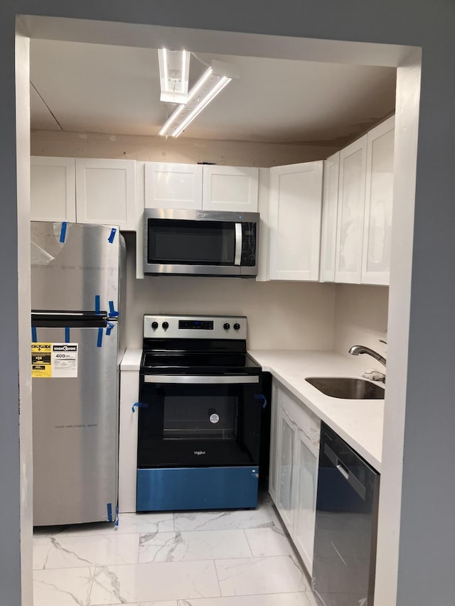 kitchen with white cabinets, stainless steel appliances, and sink