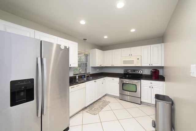 kitchen with white cabinetry, sink, light tile patterned floors, and appliances with stainless steel finishes