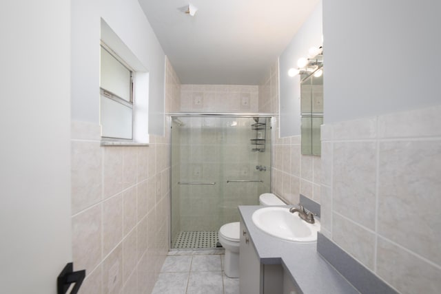 bathroom featuring toilet, vanity, tile walls, and walk in shower