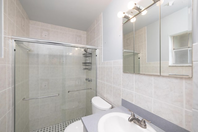 bathroom featuring vanity, toilet, tile walls, and walk in shower