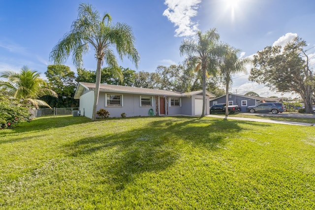 ranch-style house with a front yard, central AC, and a garage