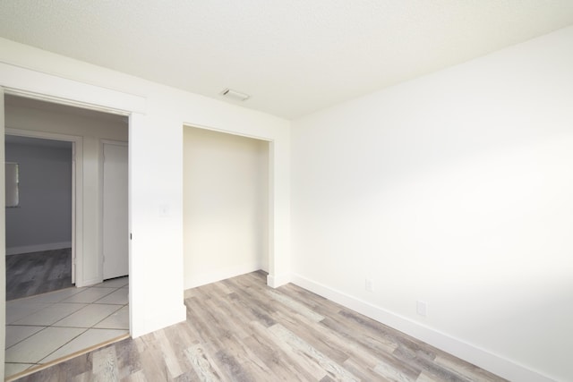 empty room with light hardwood / wood-style floors