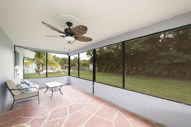 unfurnished sunroom with ceiling fan