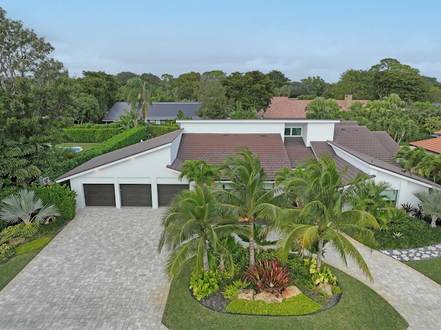 view of front of property with a garage and decorative driveway