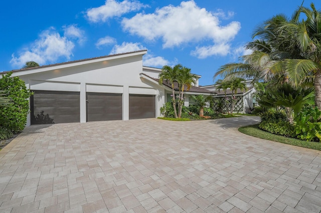 garage featuring decorative driveway