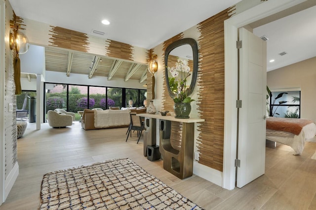 interior space with lofted ceiling, light wood finished floors, visible vents, and recessed lighting