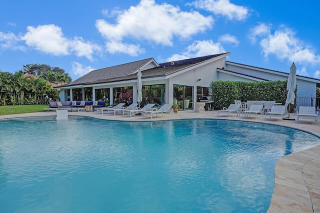 pool with a patio and an outdoor living space