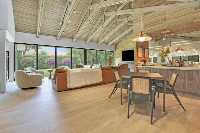 dining area featuring high vaulted ceiling, beam ceiling, light hardwood / wood-style floors, and wooden ceiling