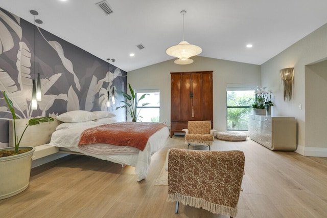 bedroom featuring lofted ceiling and light wood-type flooring